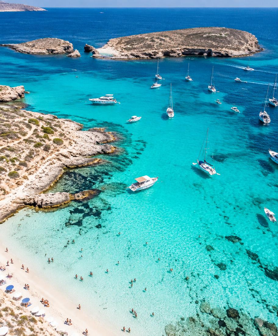 Aerial view of the Blue Lagoon on Comino with anchored boats